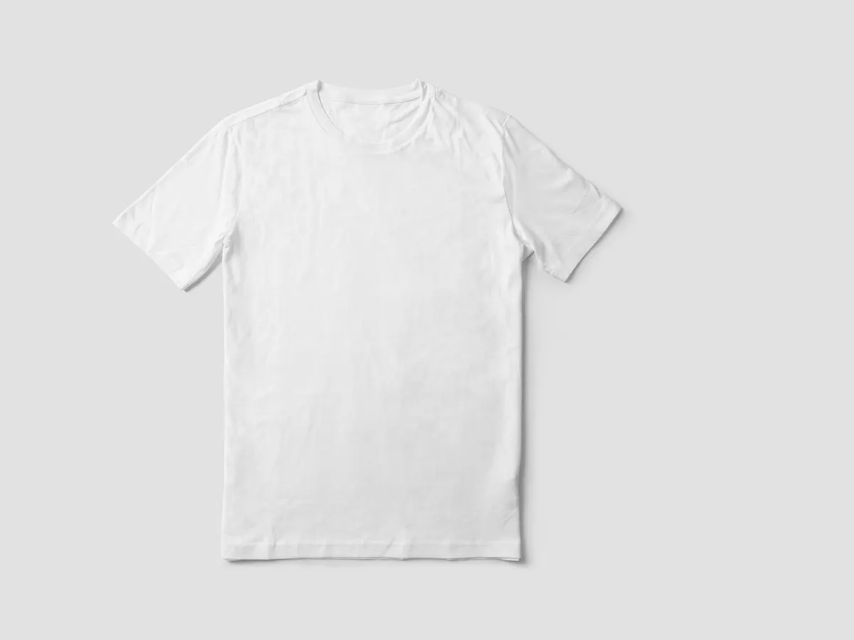 A plain white cotton crew-neck t-shirt laid flat on a light gray background, with no printing on it